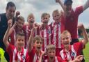 Morden Magpies U9s celebrate their victory at the Cambridge United Abbey Cup.