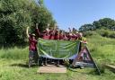 Volunteers at Oughtonhead Common celebrate their Green Flag award.