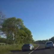 A car driving on the hard shoulder on the A1(M).