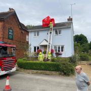 Royston firefighters retrieve the umbrella from the pub roof