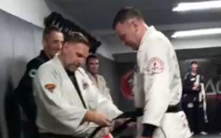 David Chastell (right) receives his black belt from instructor Gary Savage, a two-time European champion.