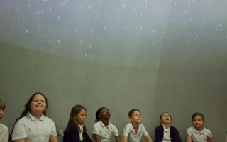 Children enjoying the planetarium at Roman Way Academy