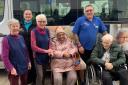 Representatives from Oxford Community Emergency Food Bank with activities co-ordinator Megan (back left), and handy person Shaun (back right), from Longlands, with residents Olga Hammerschmidt and Jamie (both seated)