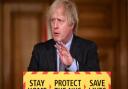 PM Boris Johnson introducing COVID-19 restrictions last year