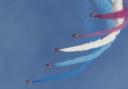 The Red Arrows display team and their iconic colourful vapour trail at a previous Duxford Summer Air Show.