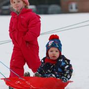 The Dennis family play in the snow in Clarence Park, St Albans. Picture: DANNY LOO