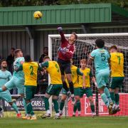 Charlie Horlock of Hitchin Town punches clear as Royston Town press at Top Field.