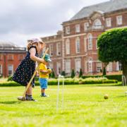 Children playing croquet on the lawn at Wimpole Estate
