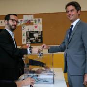 French prime minister Gabriel Attal, right, votes for the second round of the legislative election (Alain Jocard/AP)